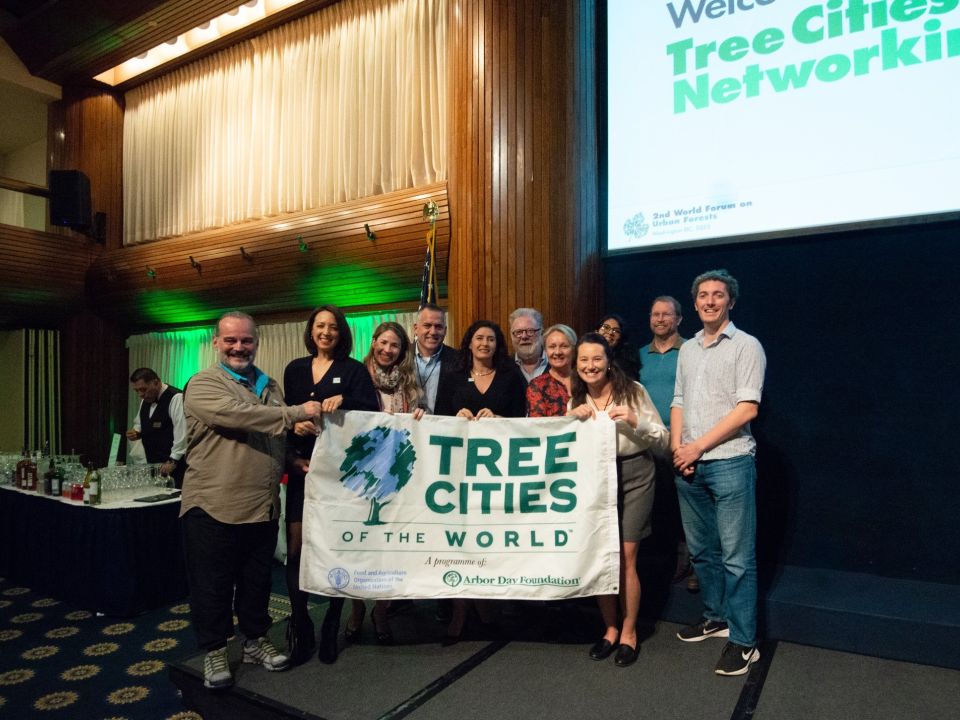 Trees for Cities staff and others who have taken part in Tree Cities of the World holding up a banner