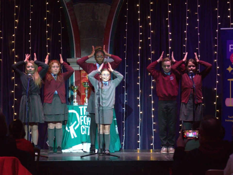 Pupils on a stage performing their poem