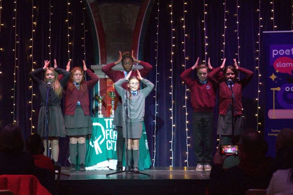 Pupils on a stage performing their poem