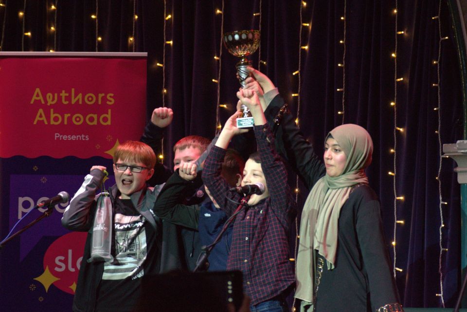 Students on stage accepting a trophy