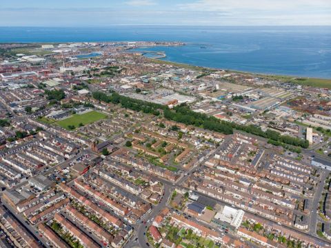 aerial view of Hartlepool, featuring rows of houses and the coastline